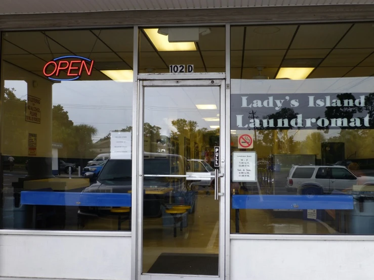 an open store window that has the name lady's island laundry and laundry