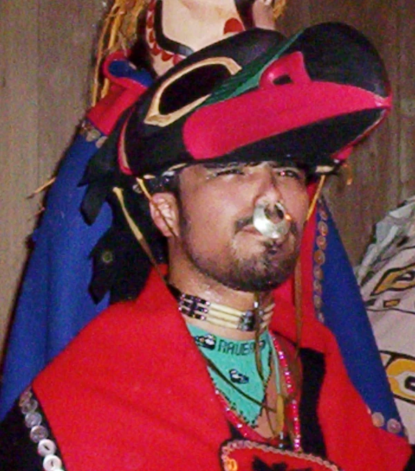 a man wearing a large hat and face paint