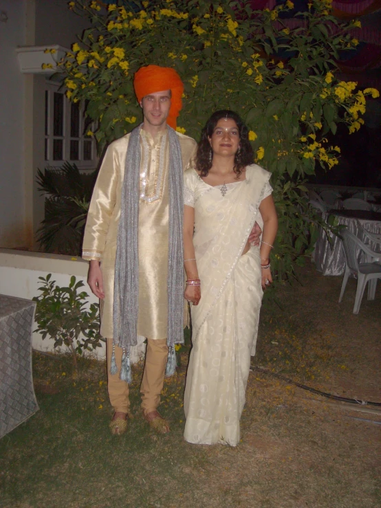 a man and woman dressed in traditional indian costume