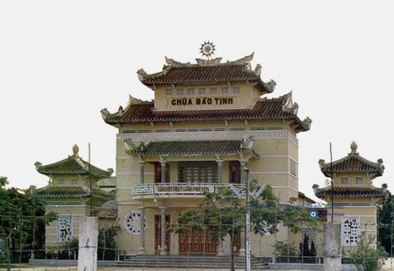 a large building on the side of a road with a gate in front