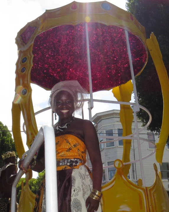 a person standing next to a yellow carnival vehicle