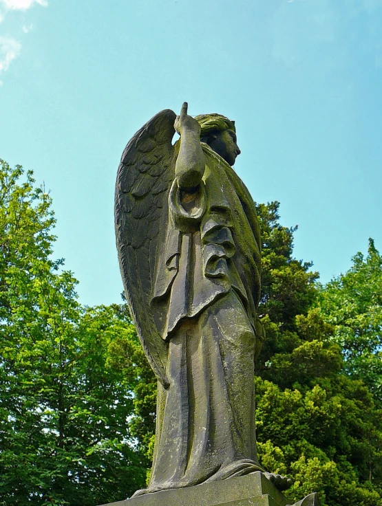 an image of a statue with a bird on it's head