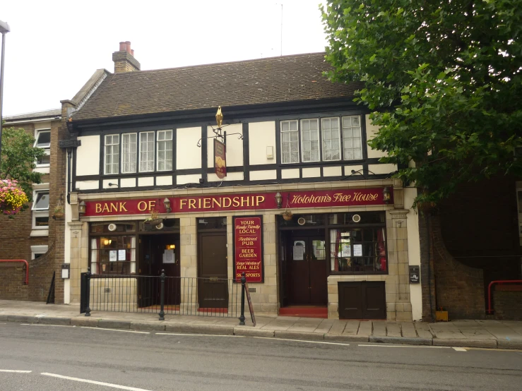 the front of a brick building with a sign saying bank of finish shop