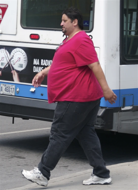 a fat man walking down a city street