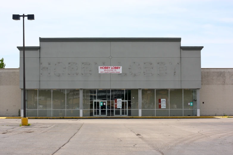 a large building with a sign and some lights