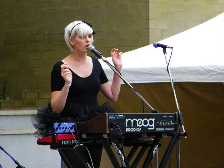 a woman that is standing up with a microphone