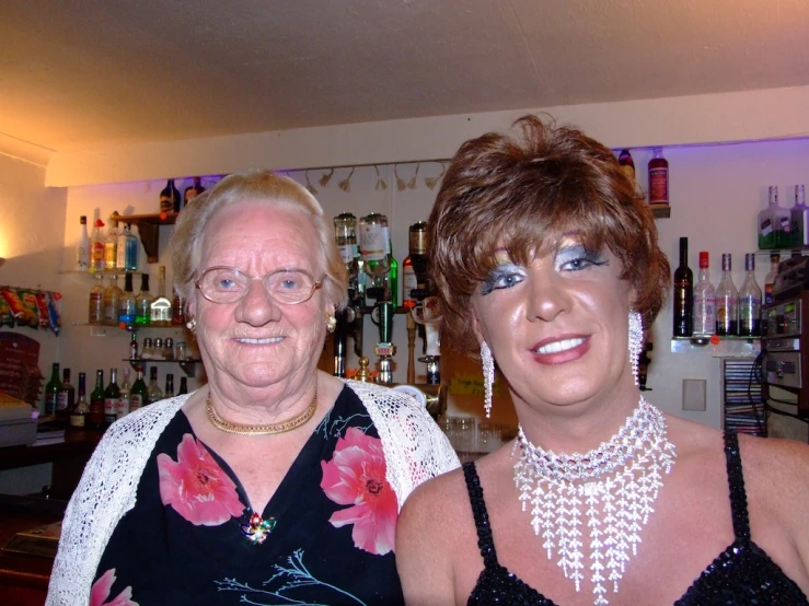 two women are posing for a picture with a bar in the background