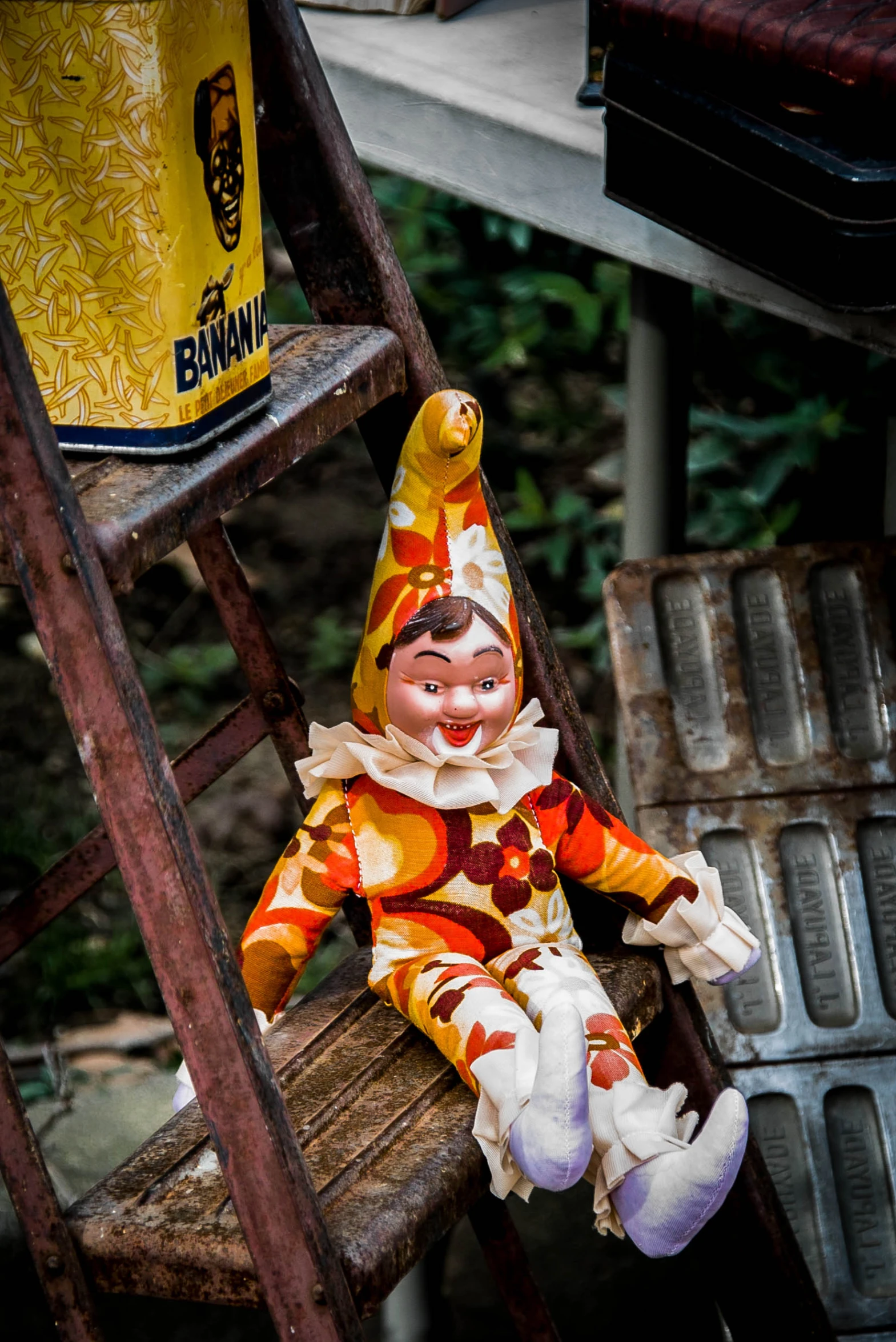 the clown is sitting on a wooden step