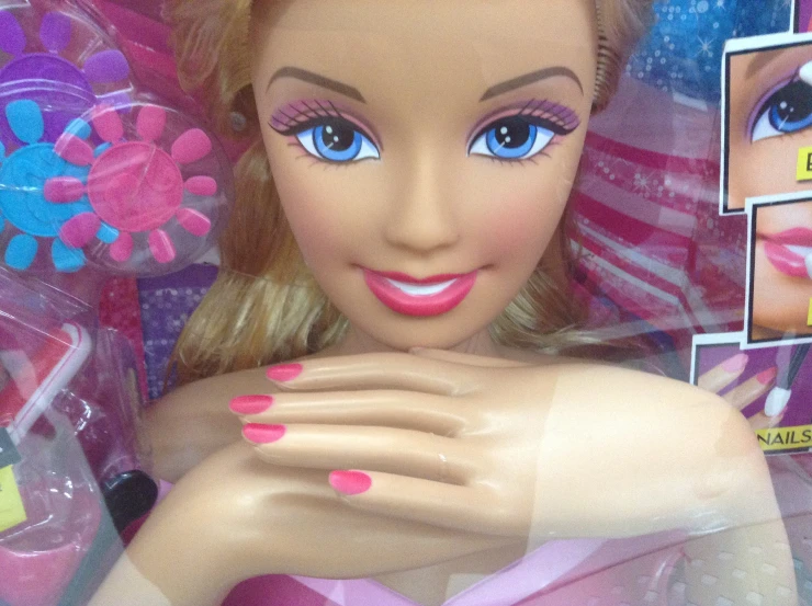 the barbie doll is wearing very bright pink makeup