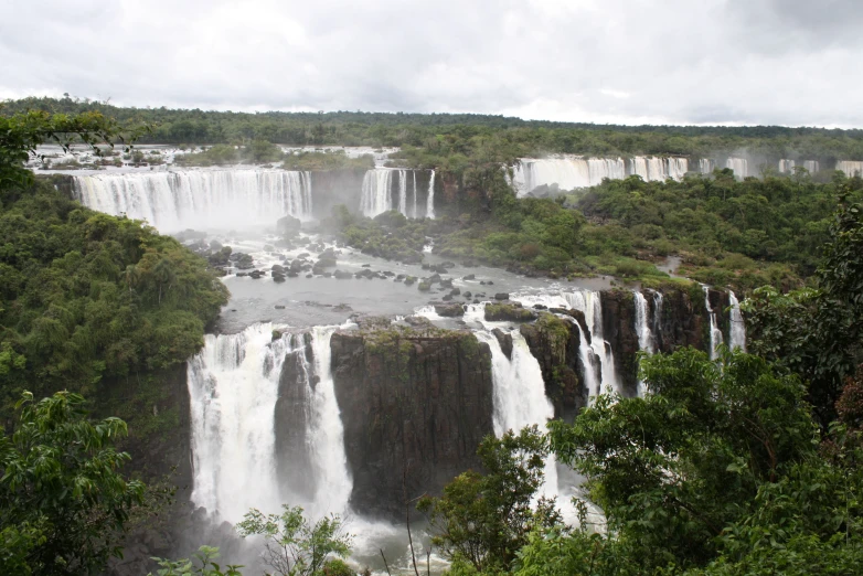 a large waterfall on the edge of a large body of water