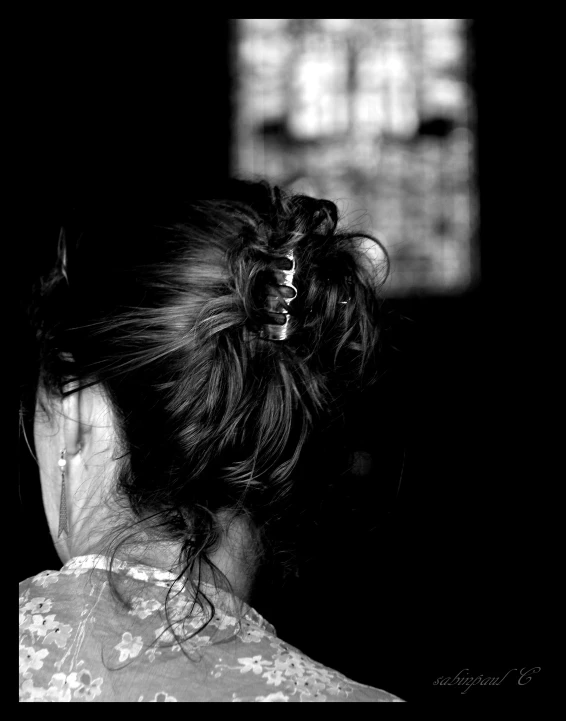 a woman with long hair standing in the dark