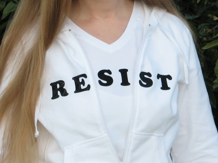 a blonde girl with glasses and a white shirt