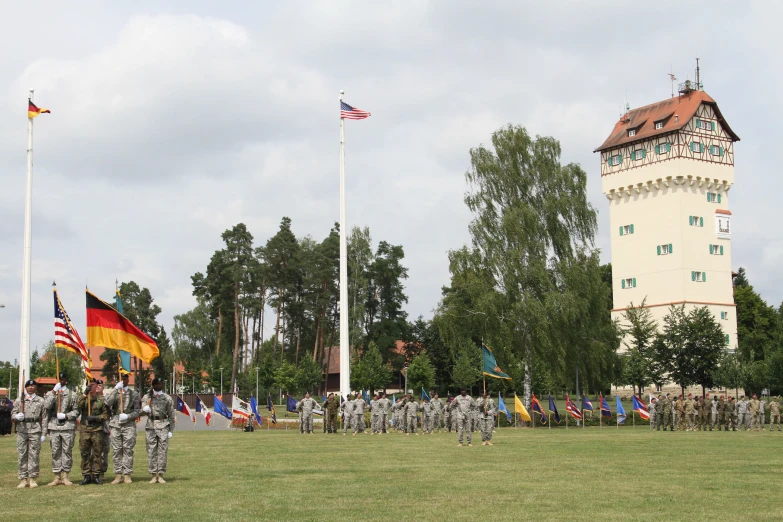 people in uniforms on a field and with flags