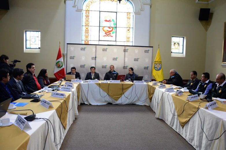 there is a group of men sitting around a table