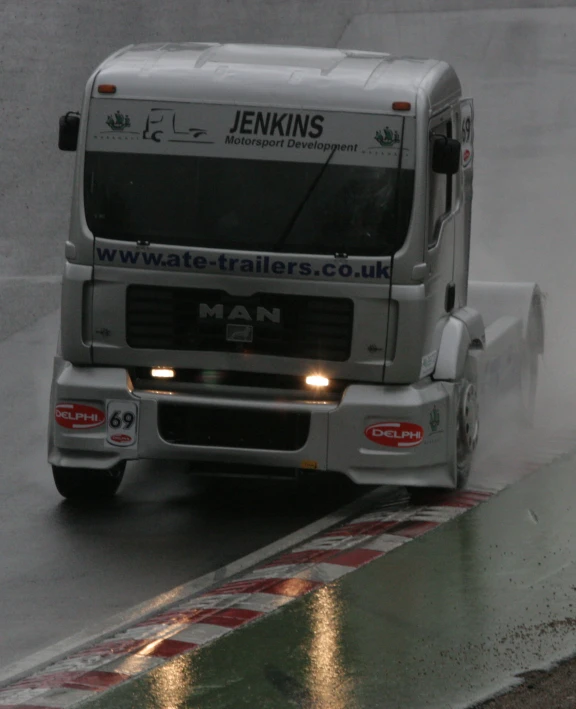 a truck on the road with the headlights lit