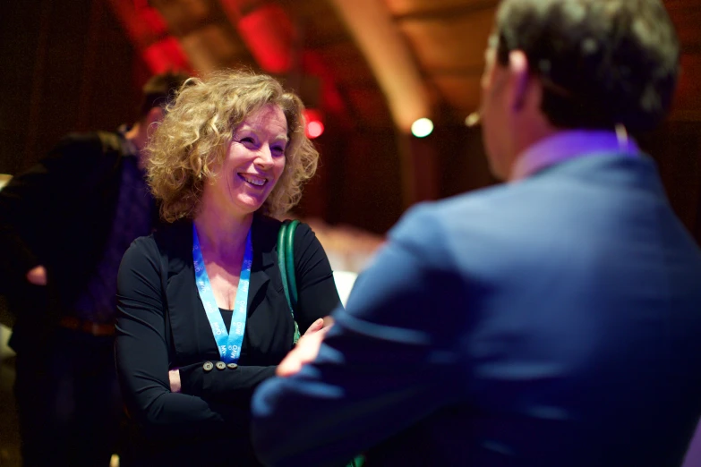 woman talking to a man in a suit and tie