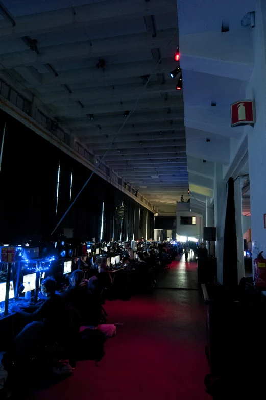 a dark room with computers sitting on the tables