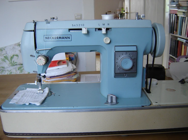 this is an old sewing machine that has some books on it