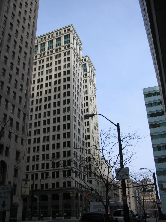 some very tall buildings are shown against the blue sky