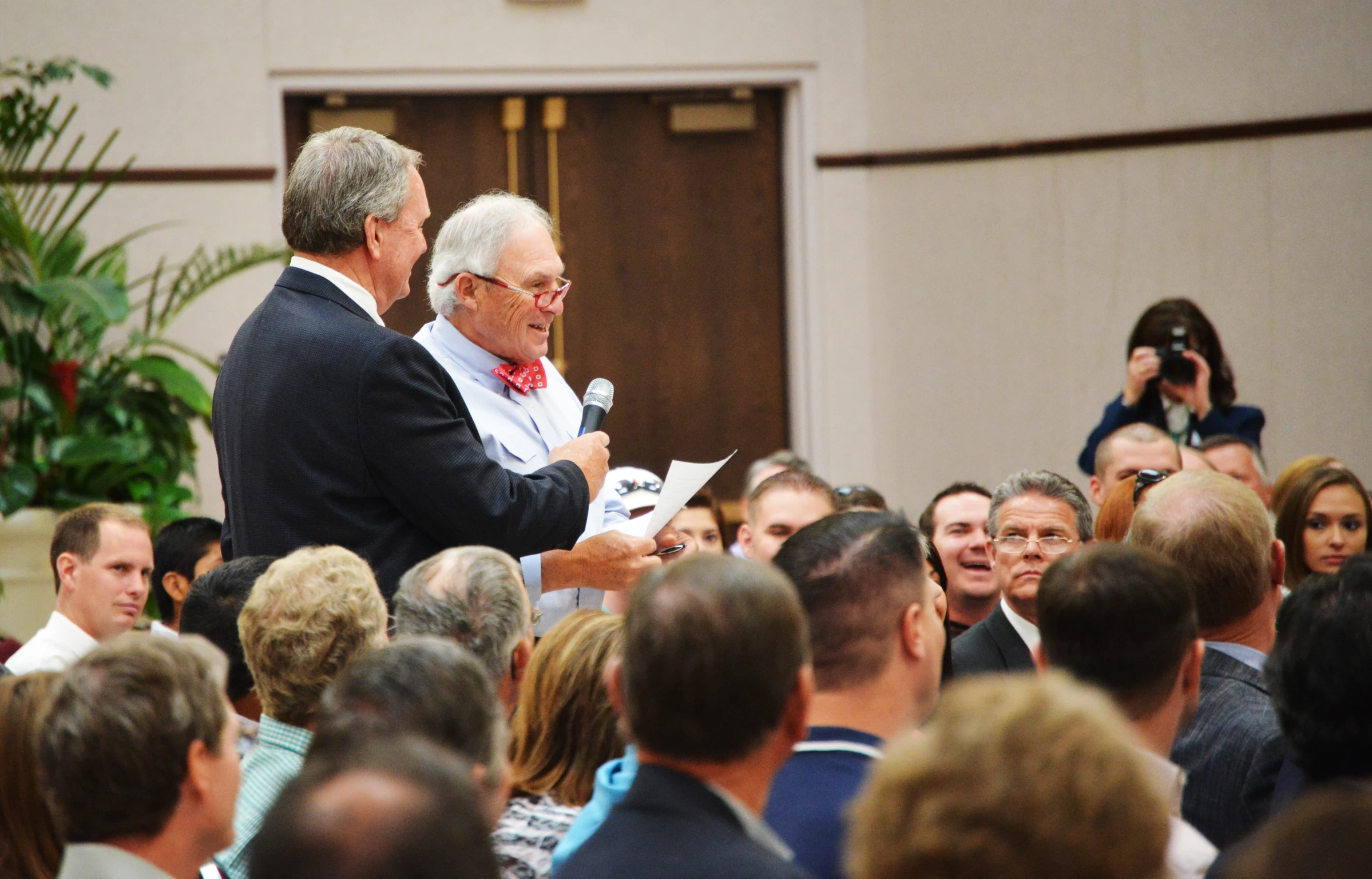 a crowd of people standing around an officer at a podium