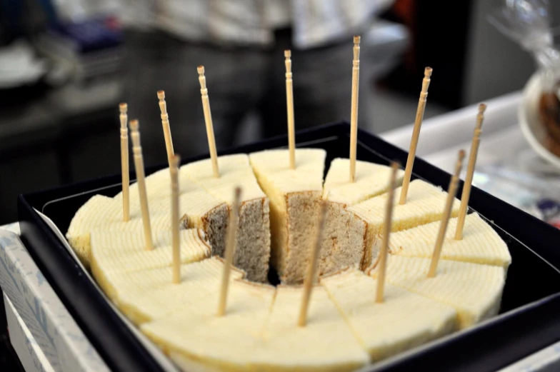 a cheese cake with toothpicks in the middle