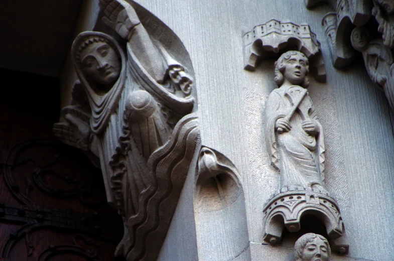 carvings of women and man on the exterior of a building