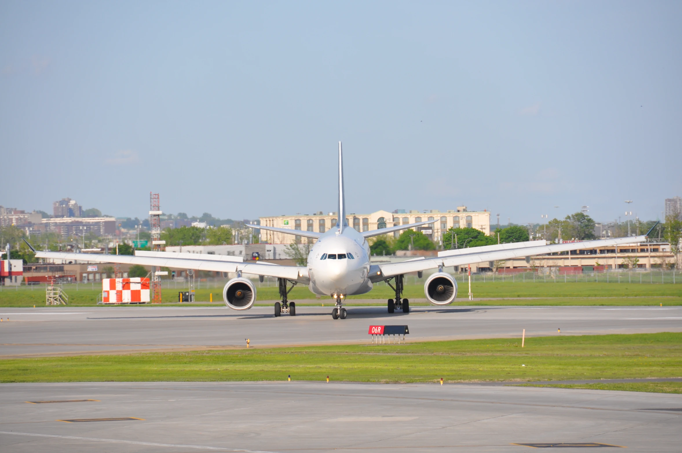 an airplane on a runway near a building