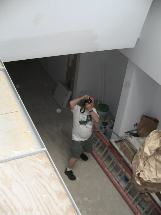 man taking a po in his new room