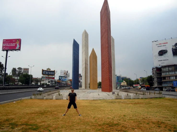 a man playing baseball in front of the obelisk