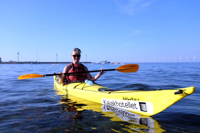 a woman rowing a kayak in the water