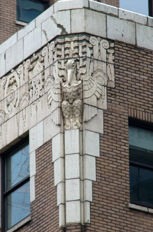 an old brick building has an eagle motif on it