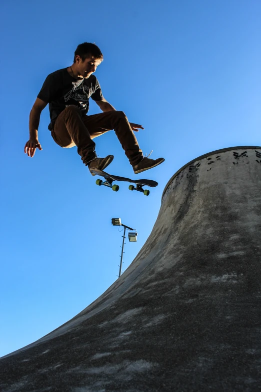 a man riding a skateboard on the side of a ramp