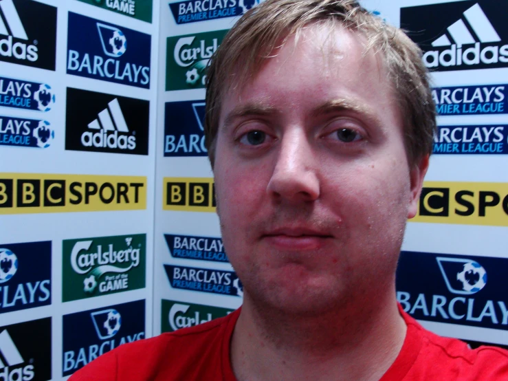 a man with blond hair in front of the bc lions wall