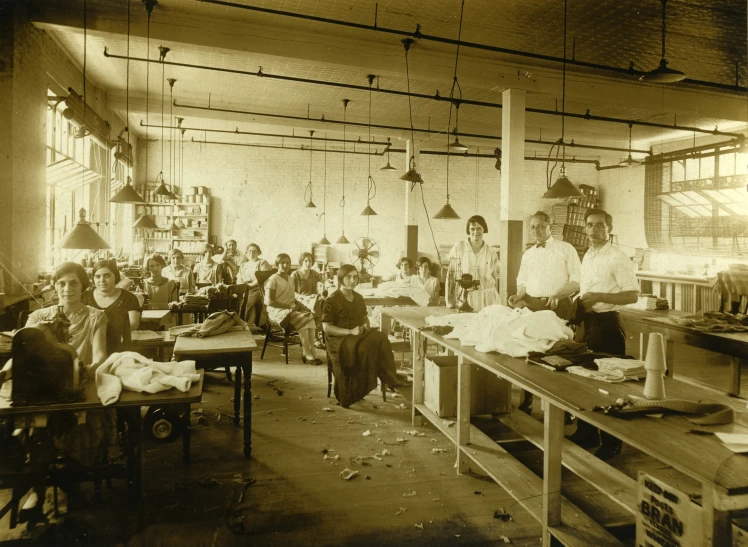 a large industrial kitchen with workers working on wood furniture