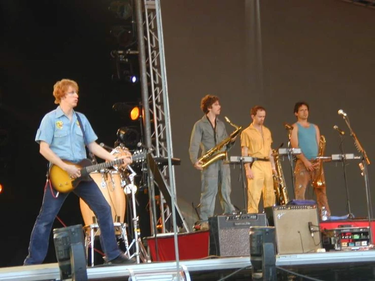 a band on stage with instruments and music playing