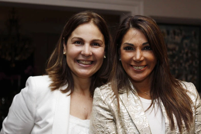 two women are posing for the camera smiling