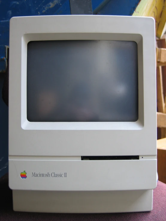 an old apple computer with screen on display