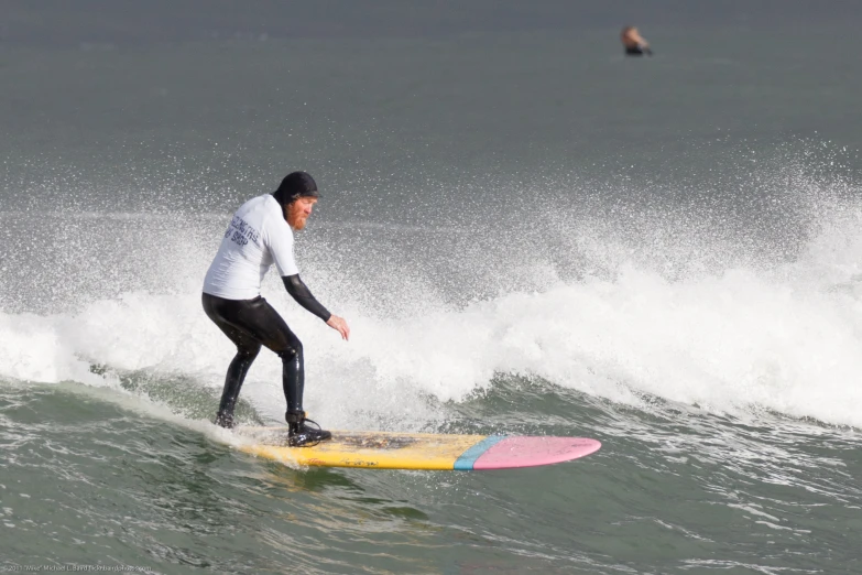 a man riding the crest of a wave on a surfboard