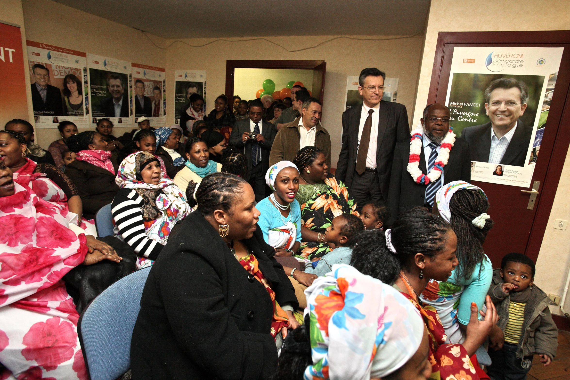 several people dressed in traditional dress and some with posters