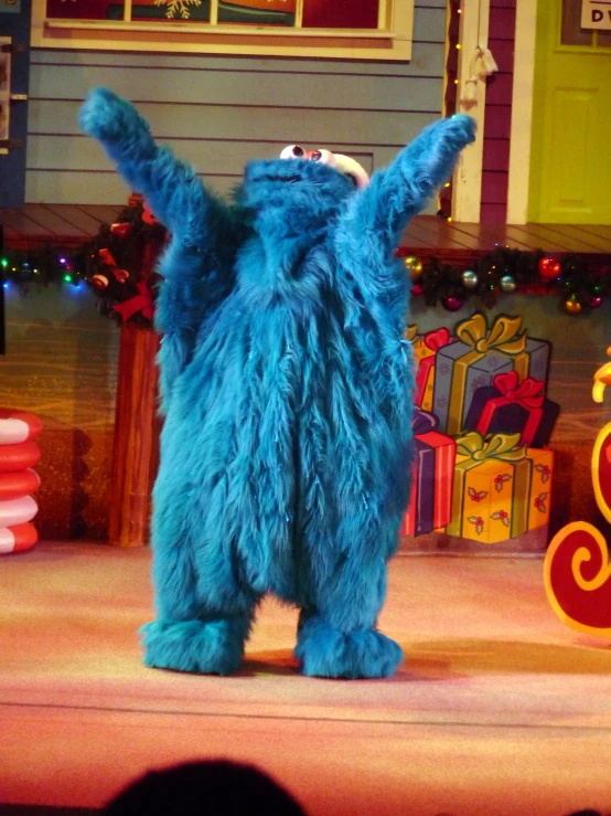 a man in blue bear suit waving to someone