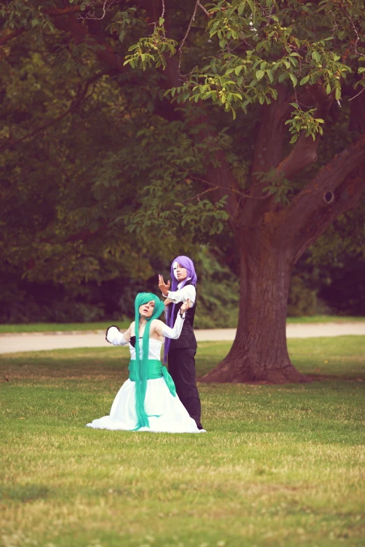 two people in costume standing in the grass