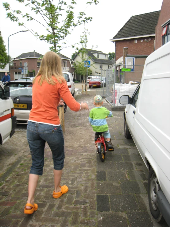 there is a child riding on the back of a bike