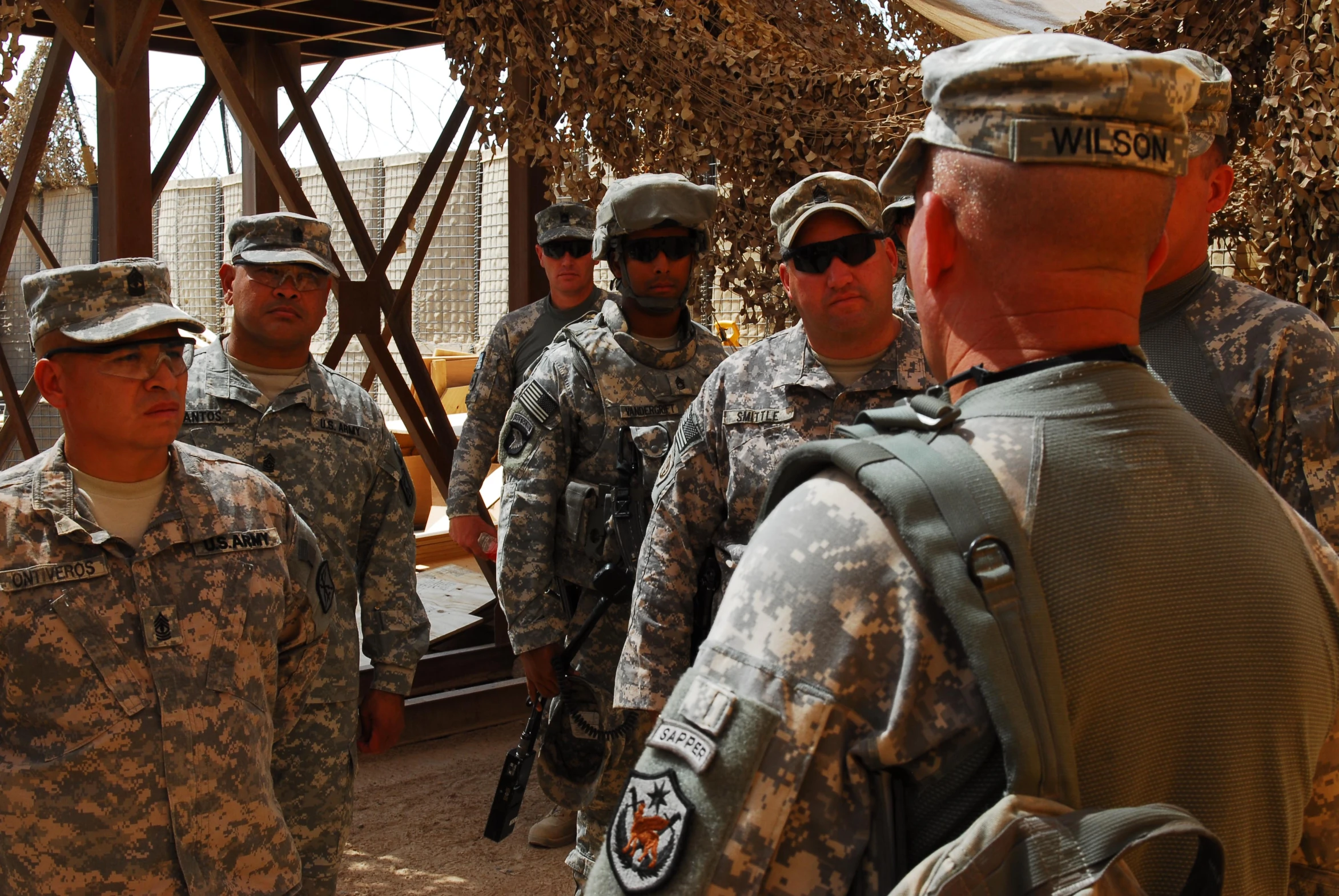 a group of soldiers standing around a wooden structure