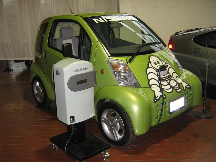 a green electric vehicle on display in a car showroom