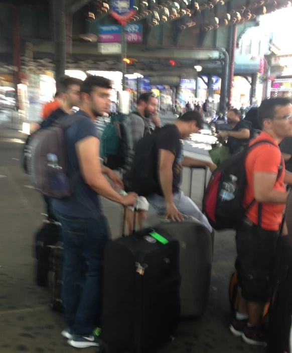 a group of people standing in a room next to luggage