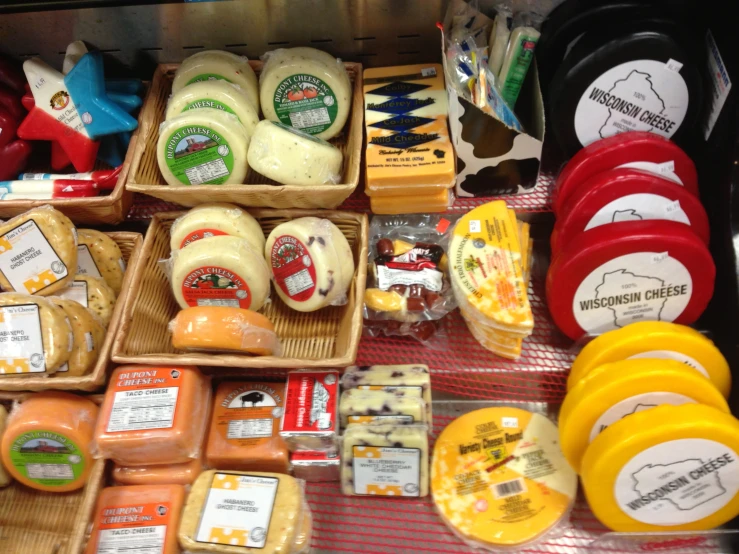 several packaged cheeses sit next to each other on a table