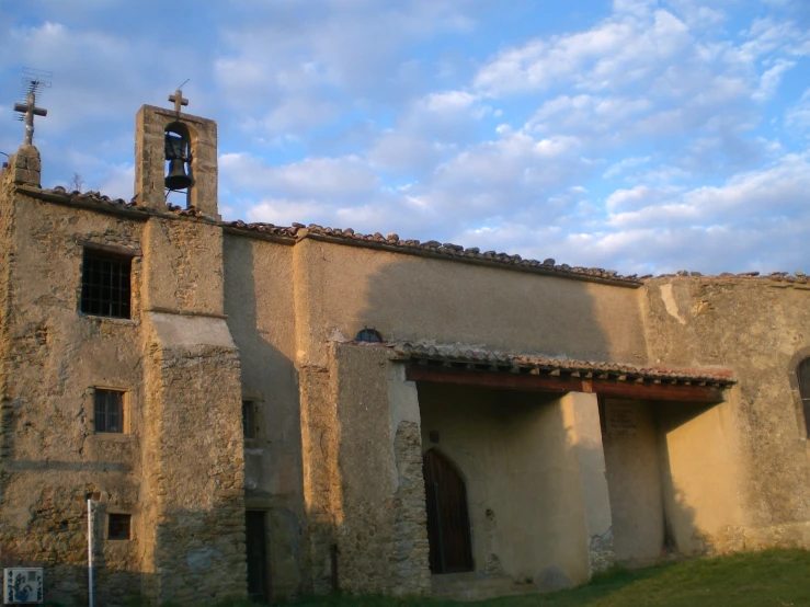 an old building with a steeple and an open front door