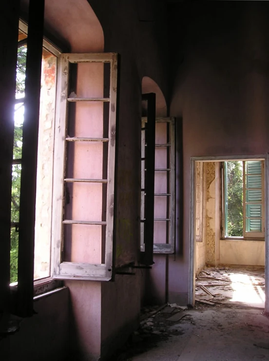 an empty room with a ladder leading to the window