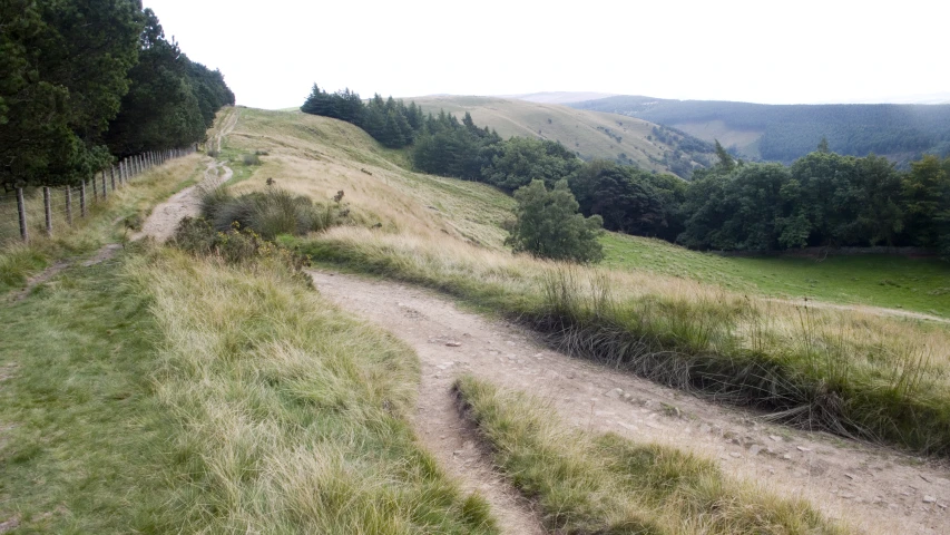 a dirt road on the side of a hill