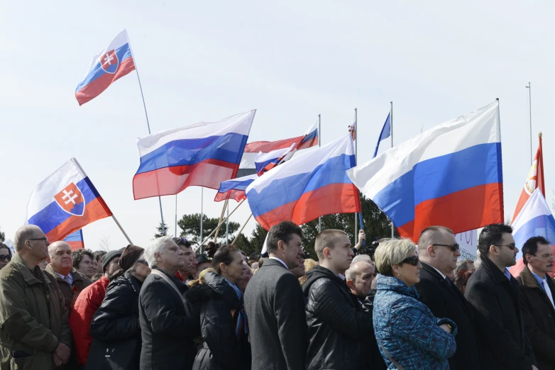 people gathered together holding flags in various states